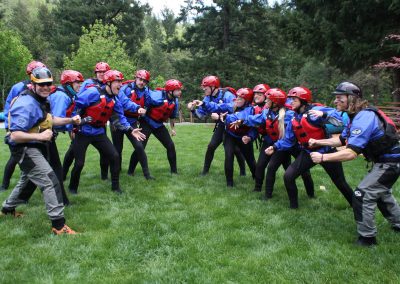 Two teams of rafters wearing face paint "facing off" against each other.